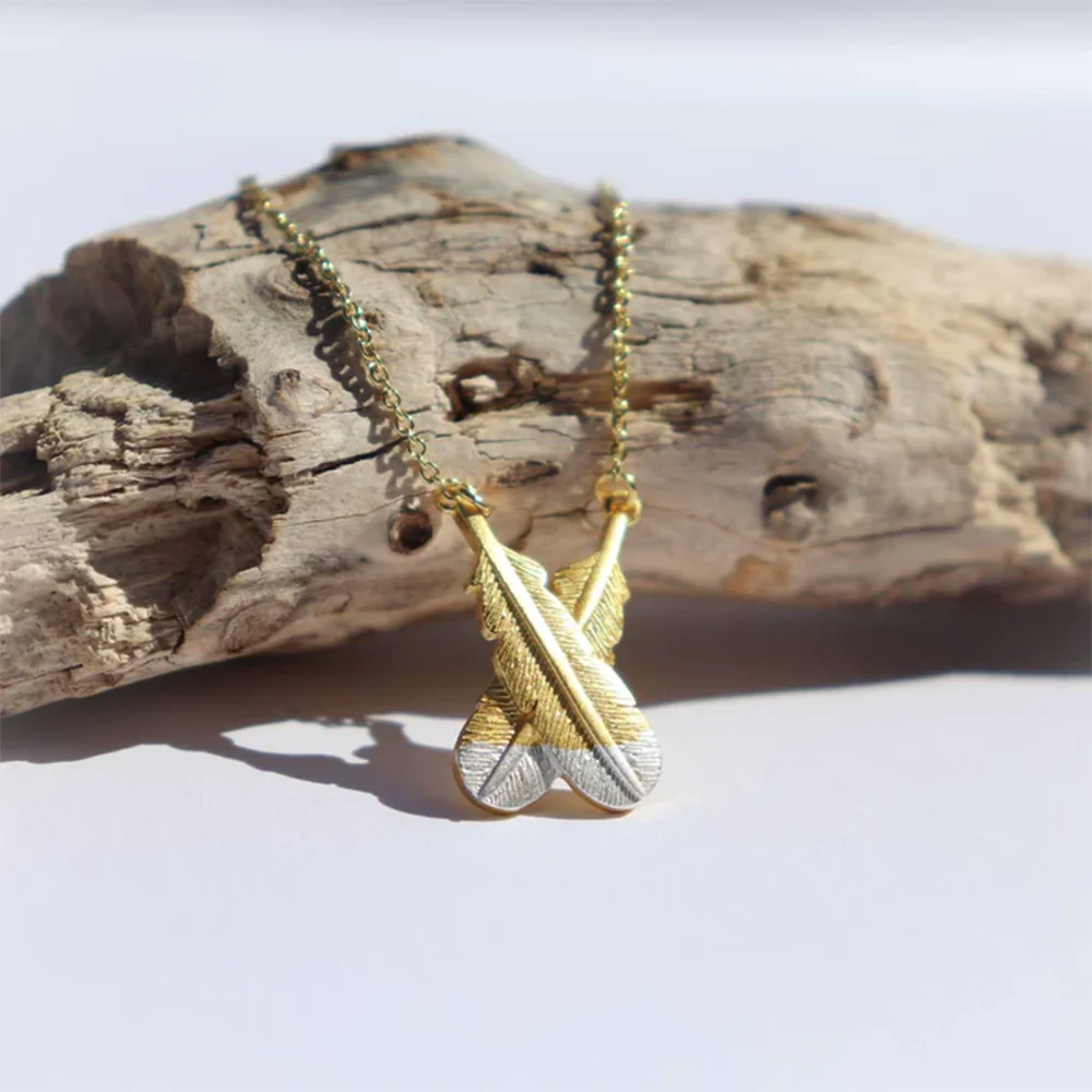 Little Taonga Necklace Crossed Huia Feathers Silver Tips on Gold - Image 2